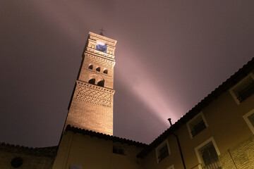 Mudejar church illuminated at dusk with fog in the Aragonese town of Tarazona