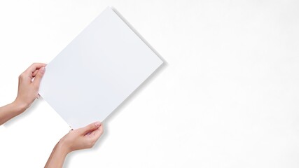 Hands holding white paper blank for a letter paper
