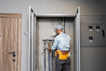 Plumber Repairing Water Pipes In Residential Building