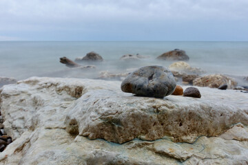 Smooth Rocks in front of misty Lake Michigan