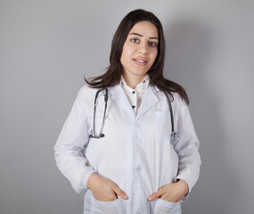Young doctor woman isolated on gray background.