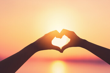 Female hands heart shape on sunset sky at tropical beach abstract background. Copy space of happy love travel and freedom in nature concept.