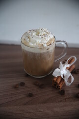 Closeup glass of coffee with cinnamon cream vanilla and coffee beans drink beverage table cup espresso latte cappuccino brown breakfast hot food eat yummy milk tasty bakery