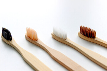 Eco-friendly bamboo toothbrushes on white background. Flat lay, top view, copy space