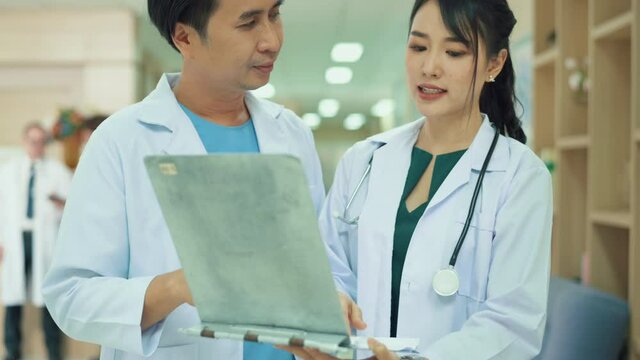 Asian Doctors are working in hospital , medical health care concept
