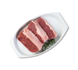 Sliced raw ancho beef, typical argentinian cut, over white plate with seasonings isolated over...