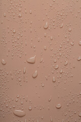 Water drops on coral  color  surface