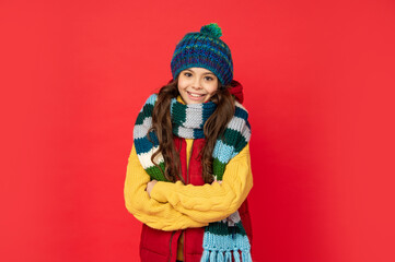 express positive emotion. winter fashion. happy kid with curly hair in hat crossing hands.