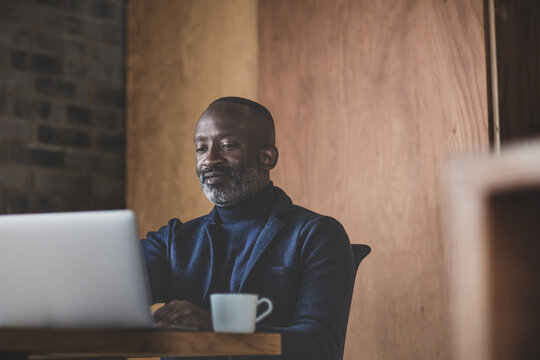 Male black business executive working at desk in office