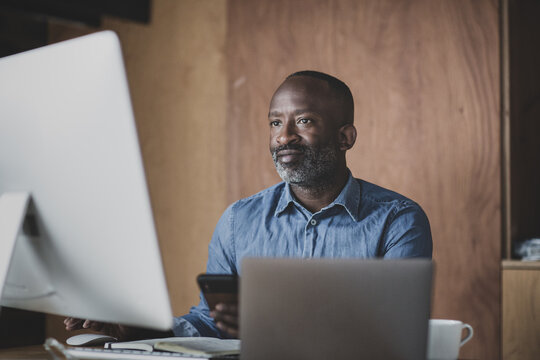 Male black business executive working at desk in office