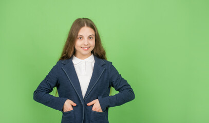 cheerful teen girl in school uniform on green background with copy space, high school