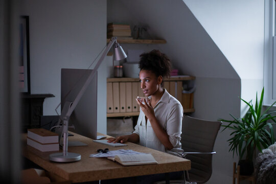 Female entrepreneur working at home on computer and smartphone