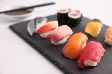 Sushi Set nigiri and sushi rolls with soy sauce and chopsticks Japanese food isolated in white background