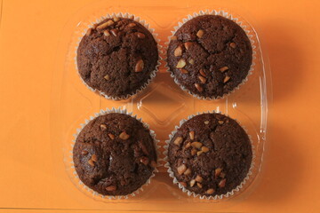 Chocolate muffin isolated on color background. Delicious chocolate muffin with nuts.