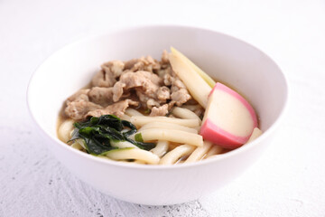 Udon noodles with pork isolated in white background