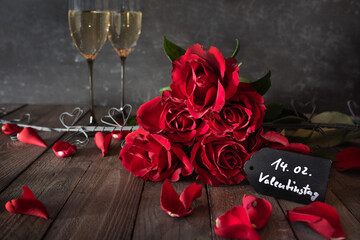 Vintage decoration with red roses and champagne. Romantic still life for valentine's day.