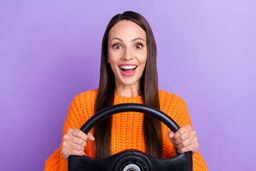 Photo of excited funky driver lady hold steering wheel wear orange sweater isolated purple color background