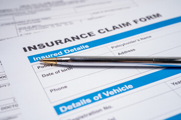 Pen on Insurance claim accident car form, Car loan, insurance and leasing time concepts.