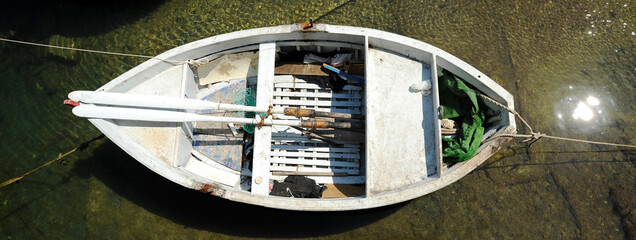 Horizontal banner or header with empty fisherman rowing boat at the port - Top view of wooden...