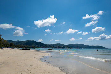 Obraz premium Kata beach in Phuket, Thailand, beach with clear water, white and golden sand, blue sky, in tropical vacation area. a beach holiday photo with copyspace.