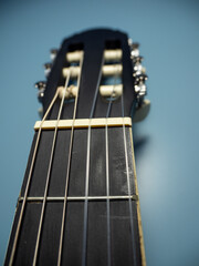 Black guitar on a blue background