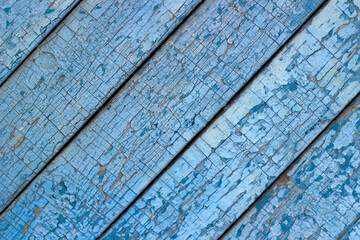 Fototapeta na wymiar Old wooden striped blue fence as background. Vintage textured. Selective focus