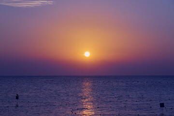 The sun rises over the Red Sea at dawn.