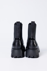 Women's black boots with genuine leather on a rough sole without laces. New collection of women's spring shoes