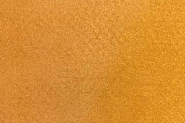 Yellow golden plaster wall abstract pattern stucco surface texture background