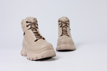 Beautiful shoes on an isolated white studio background. Fashionable beige women's shoe. Elegant stylish footwear.