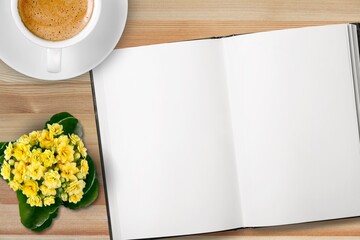 New year goals concept on desk. 2022 resolutions list with notebook, coffee cup