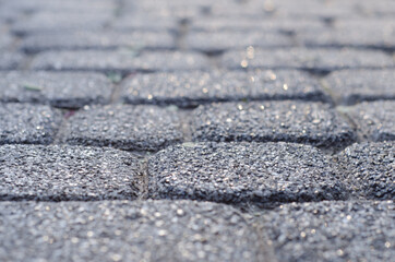 Background of paving stones. Textured gray stones close-up. Old stone road. Soft focus.	