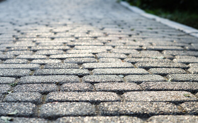 Background of paving stones. Textured gray stones close-up. Old stone road. Soft focus.	