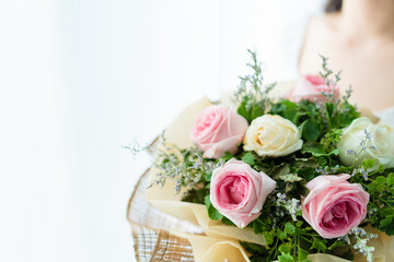 Happy Asian beautiful young woman holding a bouquet of flowers in wedding ceremony. 