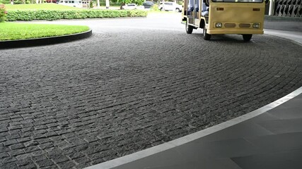 Electric shuttle bus driving with receive passengers in hotel