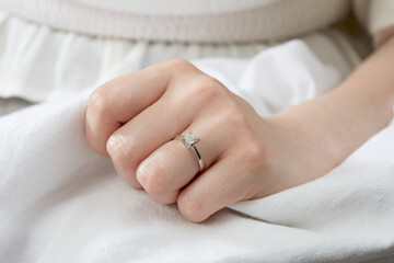 Jewelry background. Diamond ring on woman hand