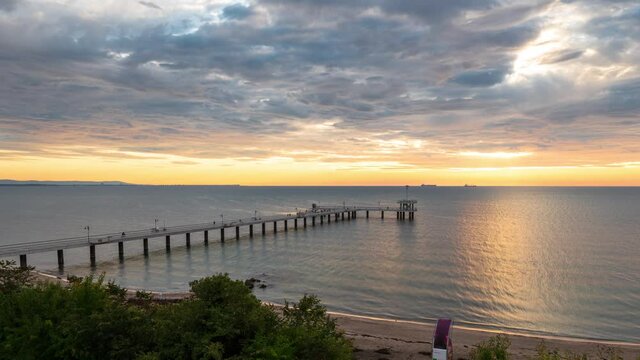 Time lapse video with colorful sunrise view of the bridge at the Black sea coast in Burgas, Bulgaria.