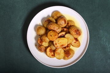 Potatoes baked in the oven are on the table