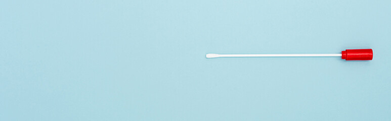 top view of medical test stick on blue background, omicron variant concept, banner.