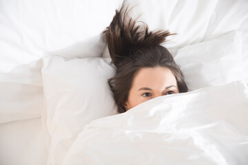 woman lying in bed under a blanket. insomnia. Healthy sleep. 