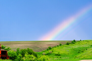 Very beautiful gentle spring photo. Rainbow on the field after  rain. Beautiful rainbow wallpaper....
