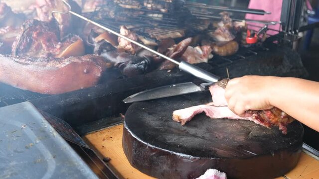 Sinalau means smoked and Bakas mean wild boar in Sabah. Meat cutting for the barbeque.