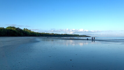 People on the beach at dawn, in Tamarindo, Costa Rica
