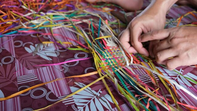 Bajau people weaving a traditional mat with a pandan straw leaves at Sabah.