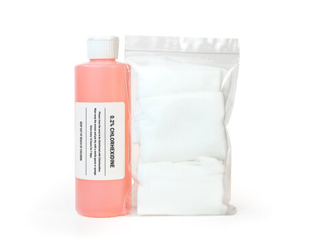 Bottle of disinfectant with bag of gauze. Fake label. Diluted chlorhexidine used in veterinary medicine and for humans as general purpose cleanser for skin, ears and oral cavity. Isolated on white.