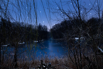A small pond during night with stars