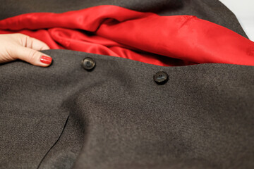 The dressmaker will open the fabric for the future costume for further work. Fashion designer tailor in the workshop of the studio, developing a new collection of clothes. 