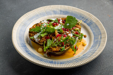 baked eggplant on plate on grey concrete table