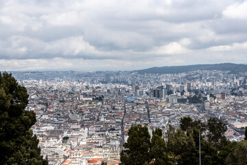 Cityscapes of the capital of Ecuador - Quito from the mountain on a cloudy day 