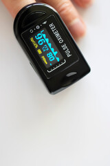 Black pulse oximeter on a white background.